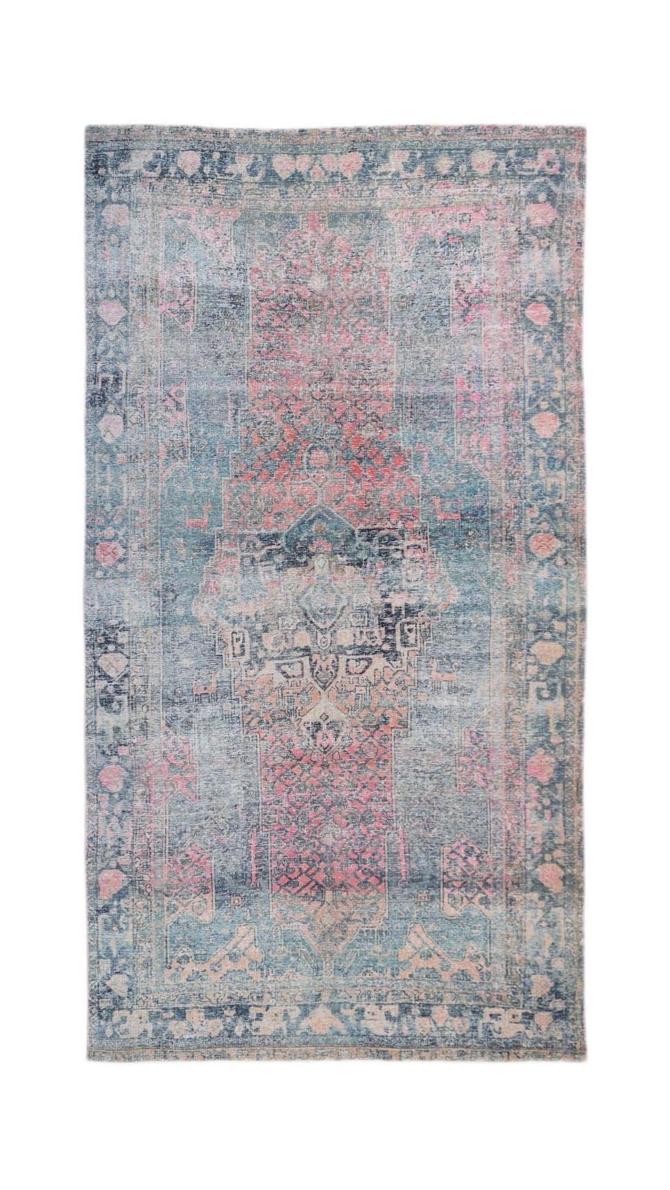 A vintage Persian Mazlaghan rug featuring a distressed blue and pink geometric pattern.