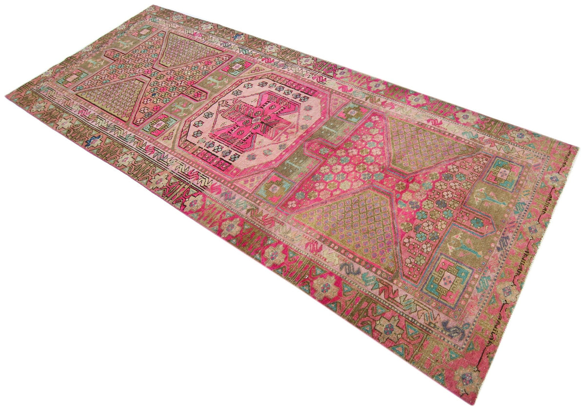 Vintage Persian Meshkin rug featuring a bold geometric medallion design in faded madder red, indigo blue, and earthy tones.