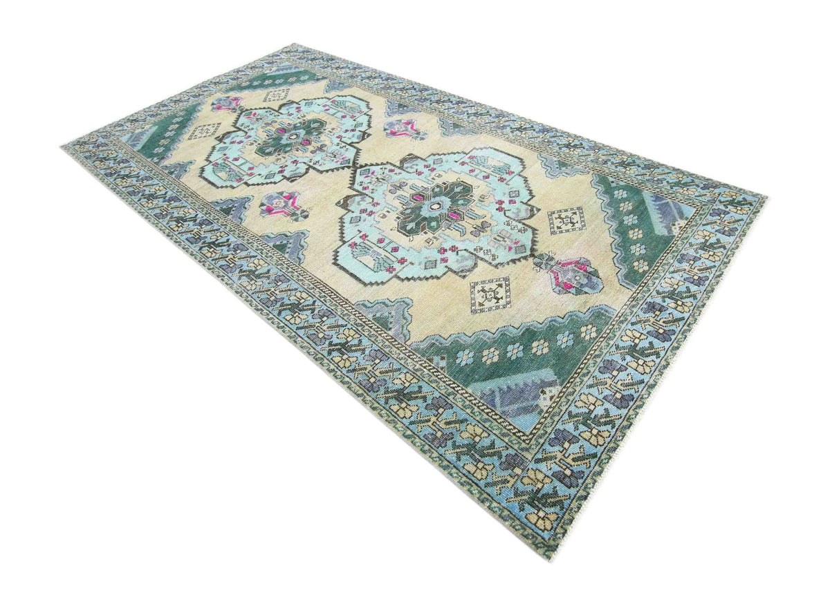 Vintage Persian Meshkin rug featuring a central medallion, geometric patterns, and a palette of soft blue, green, and cream.