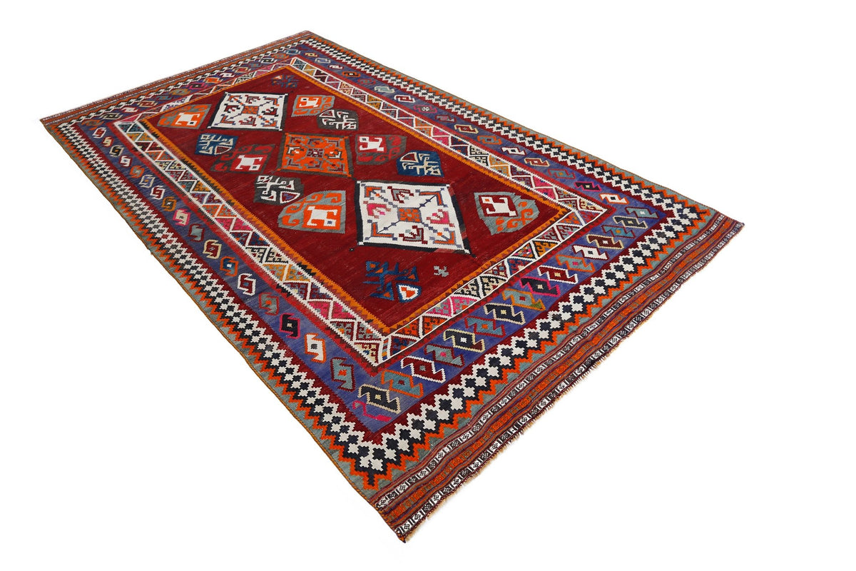 Handwoven red Persian Qashqai kilim with geometric diamond patterns and multicoloured tribal motifs.