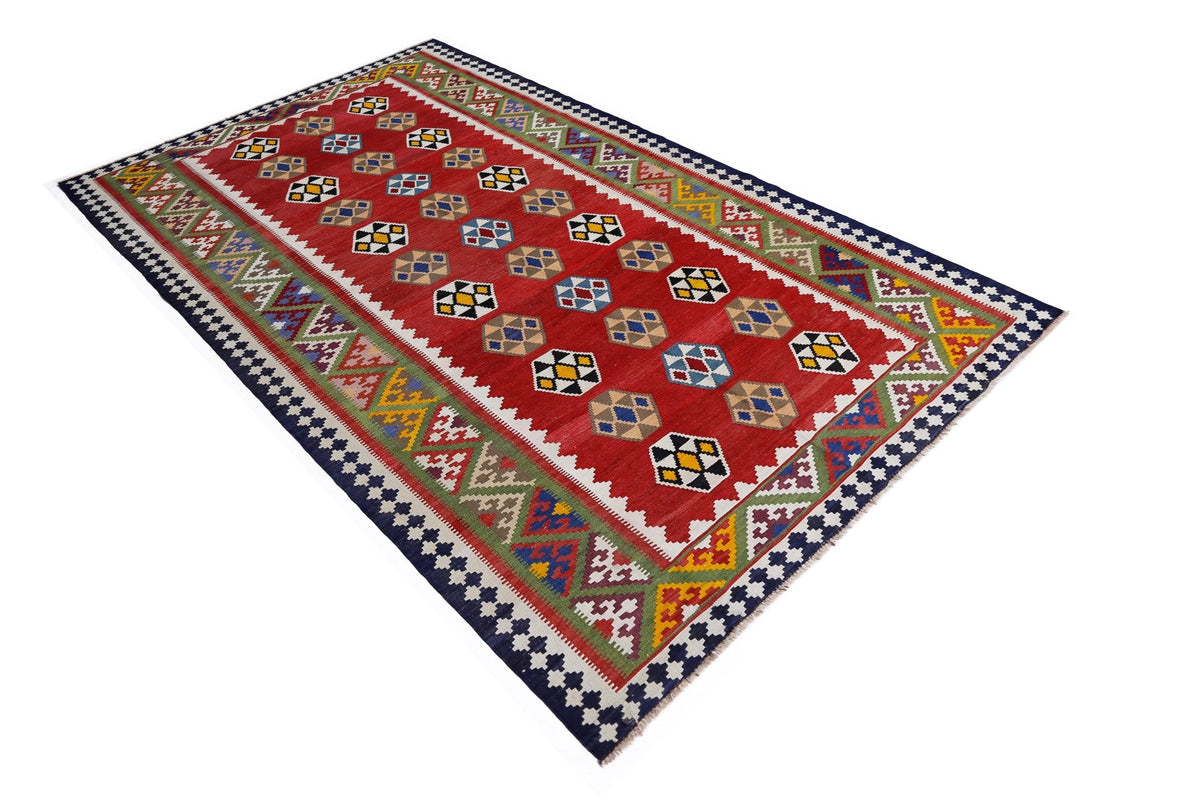 Handwoven red Persian Qashqai kilim with geometric diamond patterns, colourful tribal motifs, and a dark blue border.
