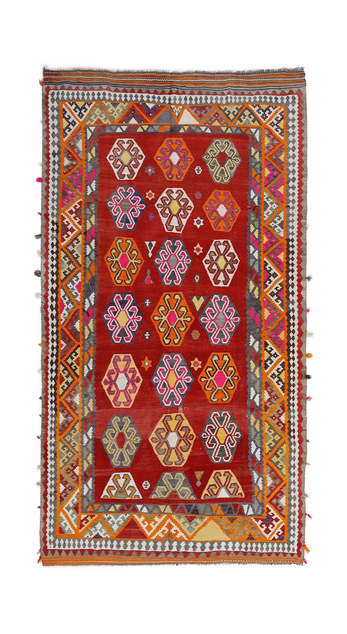 Handwoven red Persian Qashqai kilim featuring geometric hexagonal motifs, vibrant multicoloured patterns, and a fringed edge.