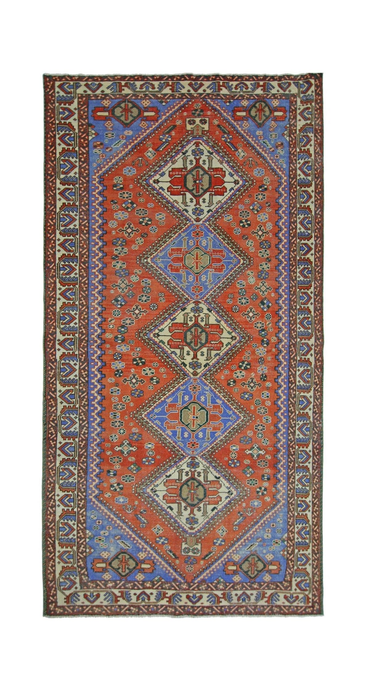 A vintage Persian Ghashghai rug featuring a geometric diamond pattern in red and blue tones.