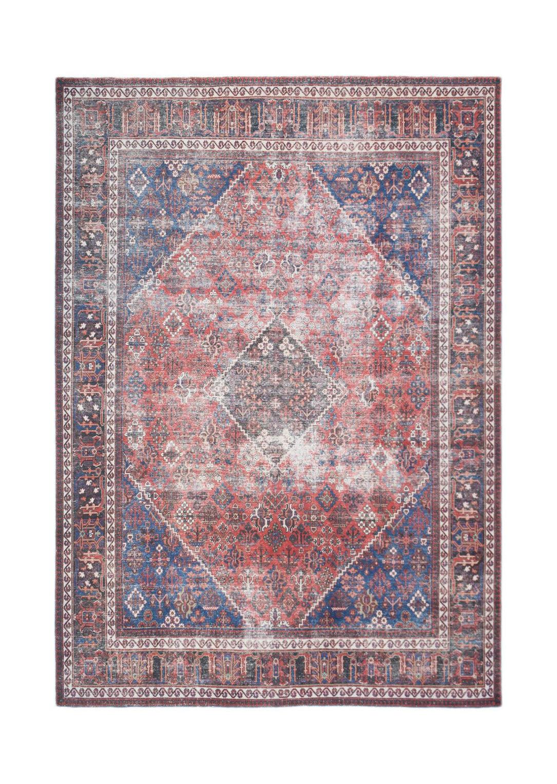 A vintage Persian Ghashghai rug featuring a distressed red and blue geometric medallion pattern.