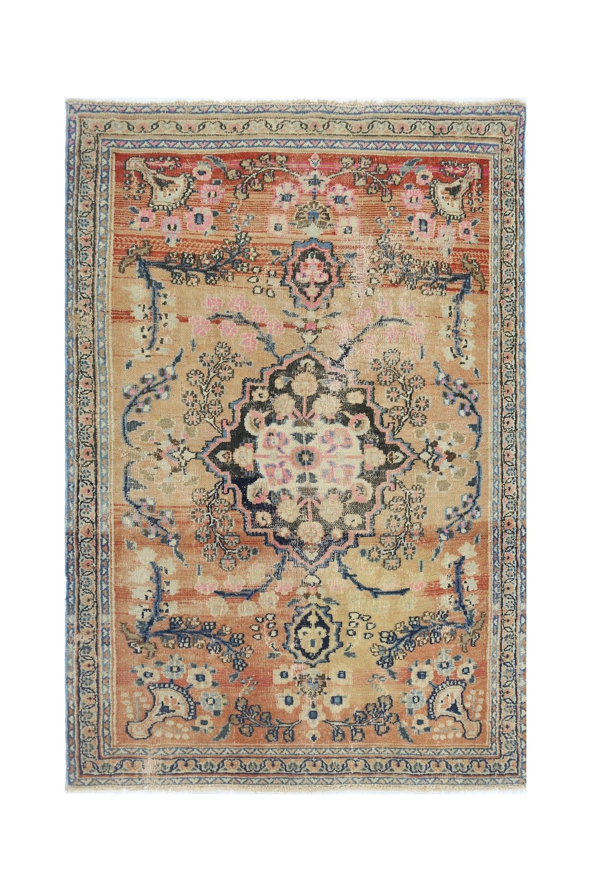 A vintage handmade Persian rug featuring a central floral medallion on a tan and orange field.