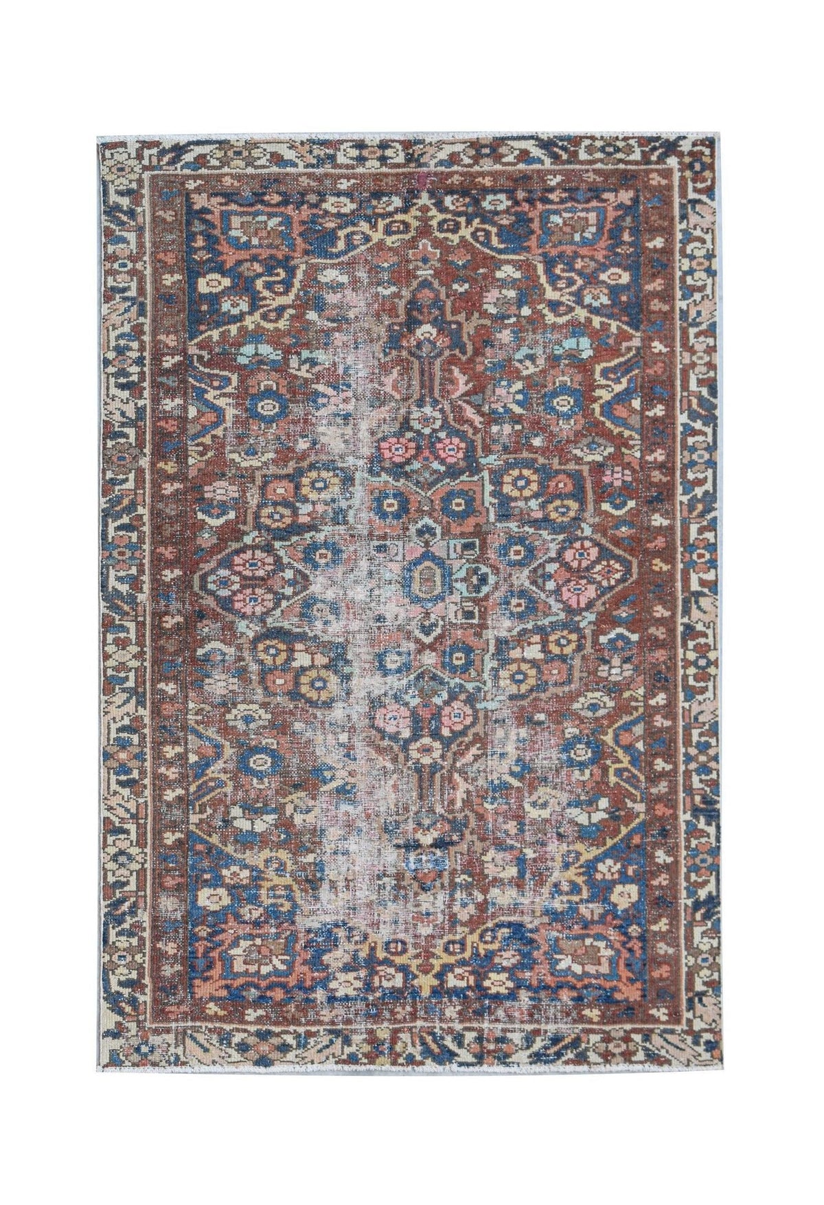 A handwoven vintage Persian rug featuring a distressed floral pattern in blue and terracotta tones.