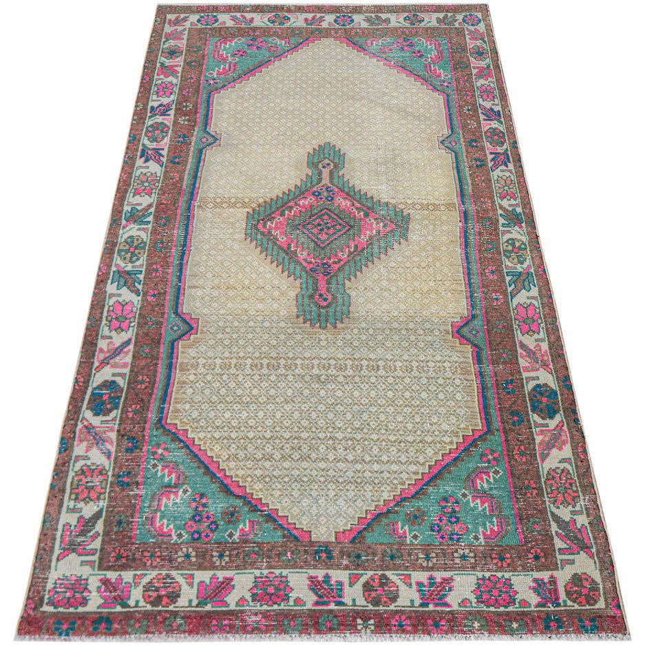 A vintage handwoven Persian rug featuring a central geometric medallion on a beige field.
