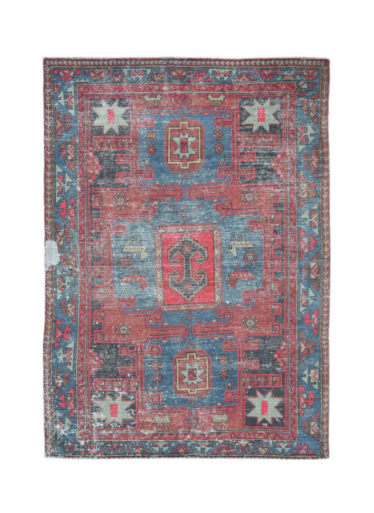 A vintage handwoven Persian rug featuring a geometric pattern in shades of red and blue.