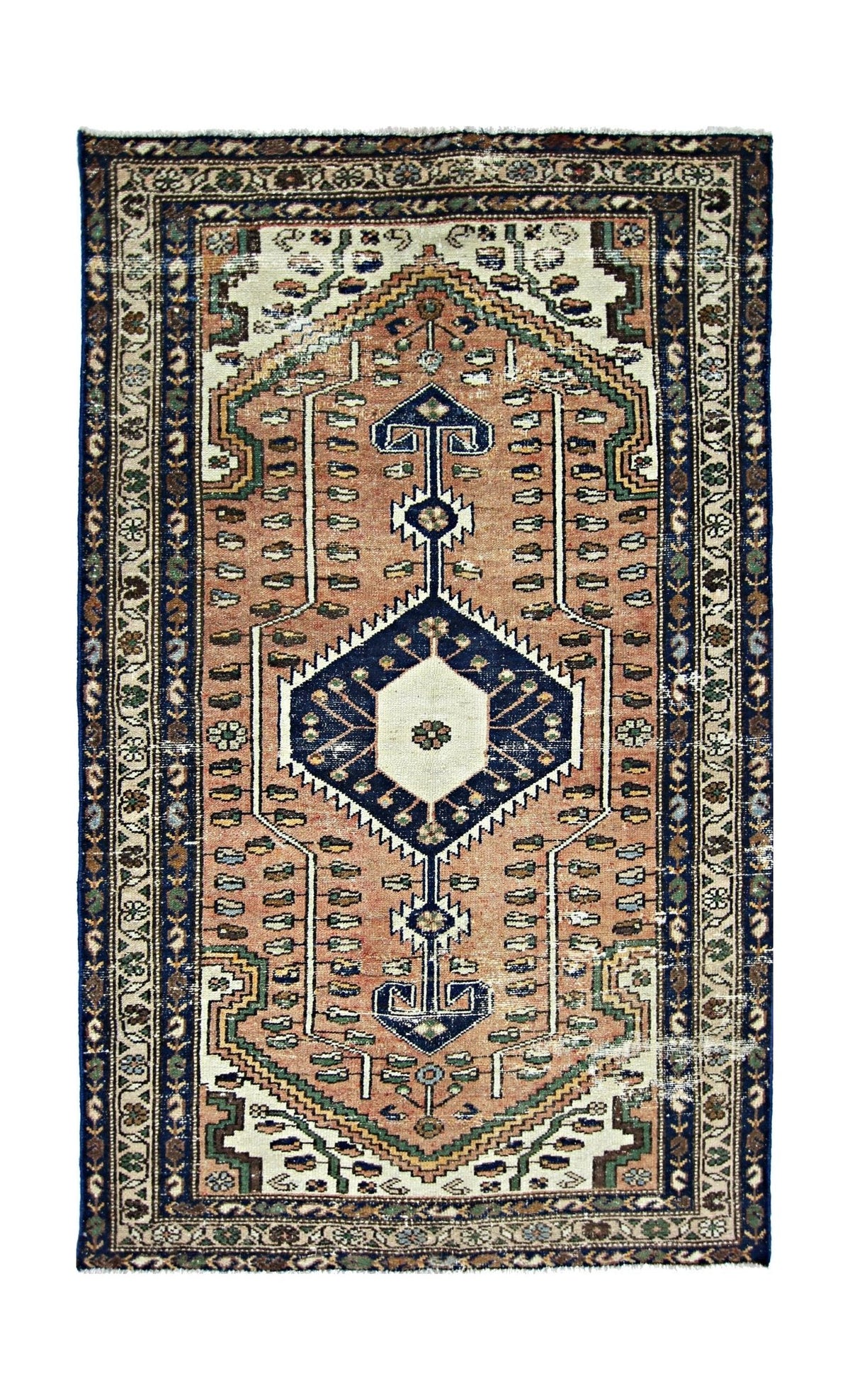 A vintage Persian rug featuring a central geometric medallion on a salmon field with floral borders.