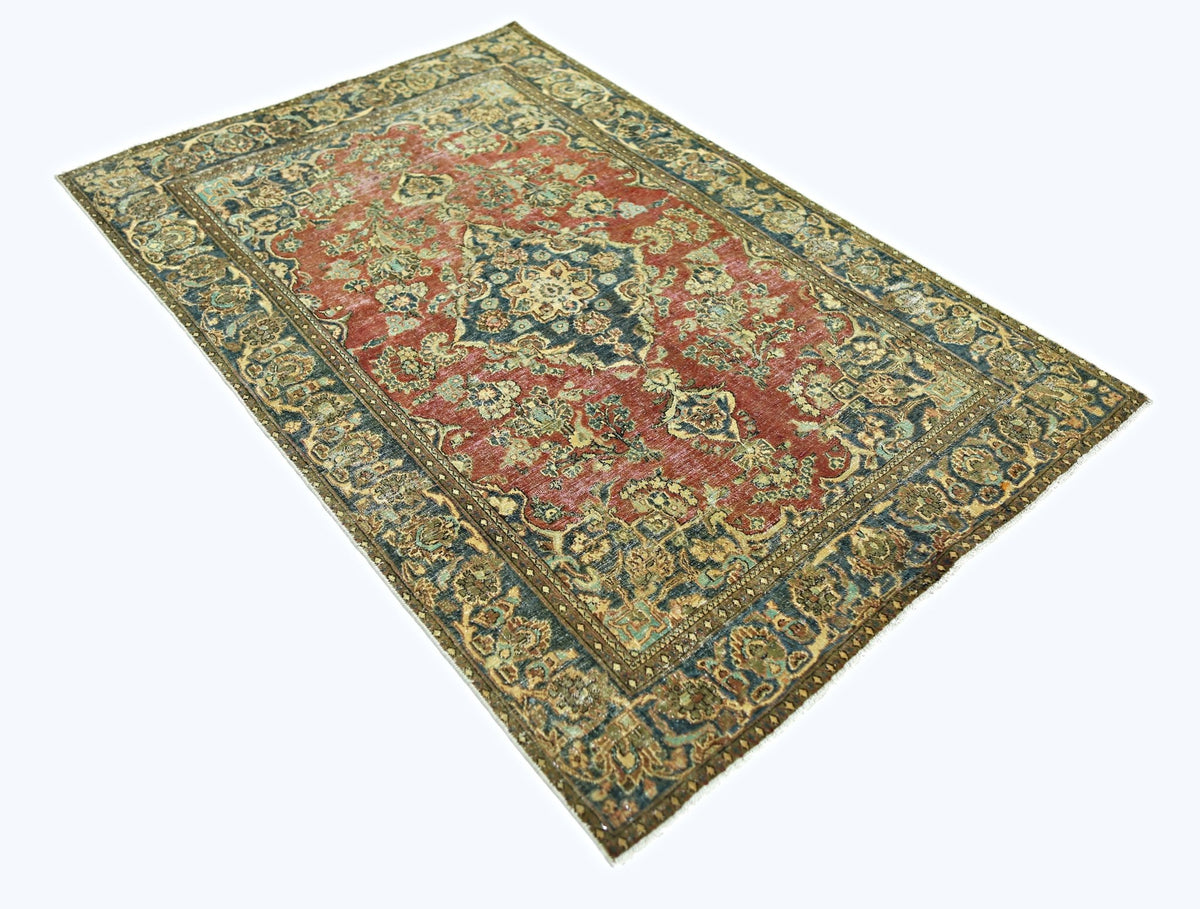 A vintage Persian rug featuring a central medallion pattern in red, blue, and beige tones.