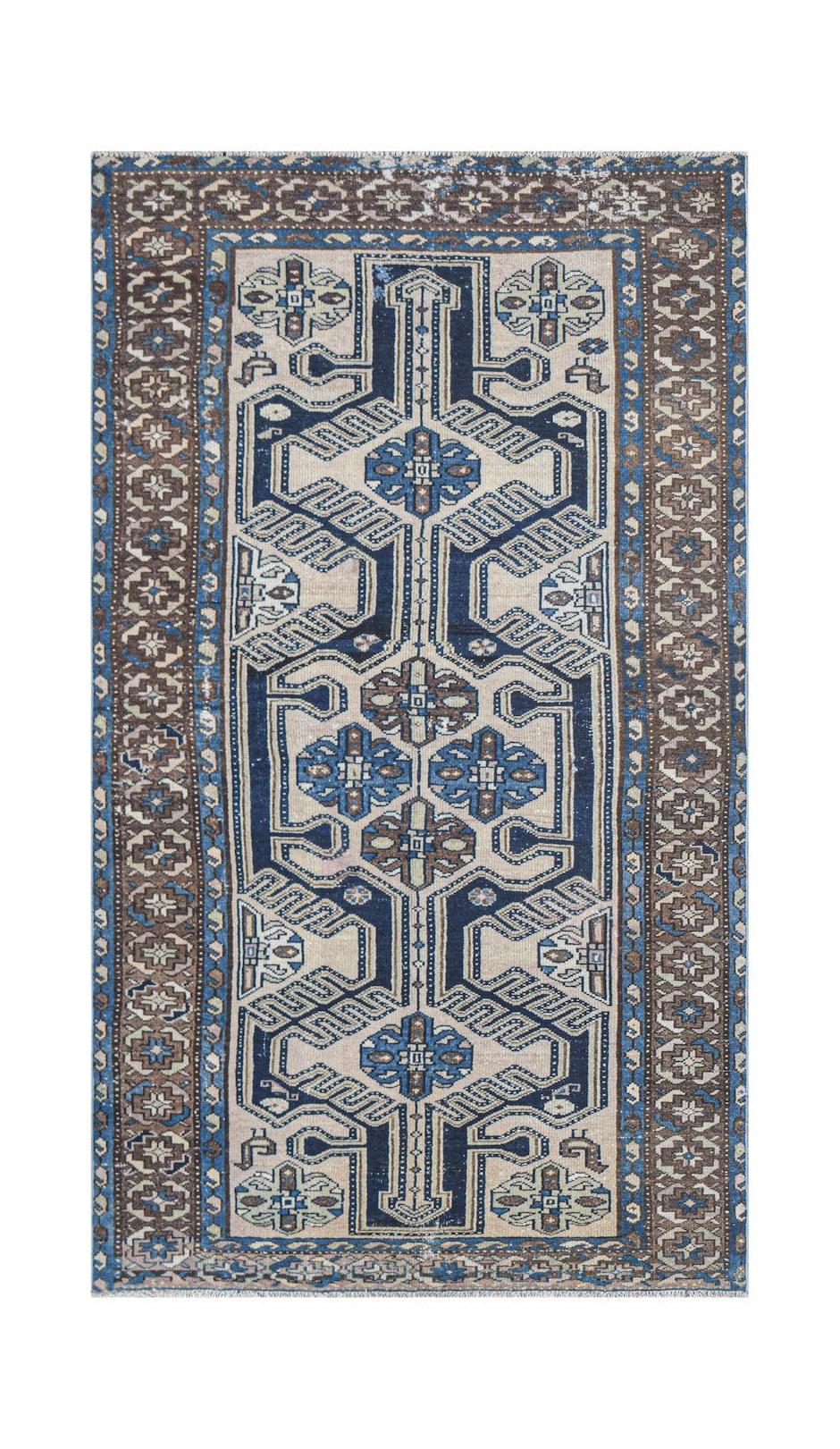 Vintage Persian rug with a geometric pattern in blue and brown.