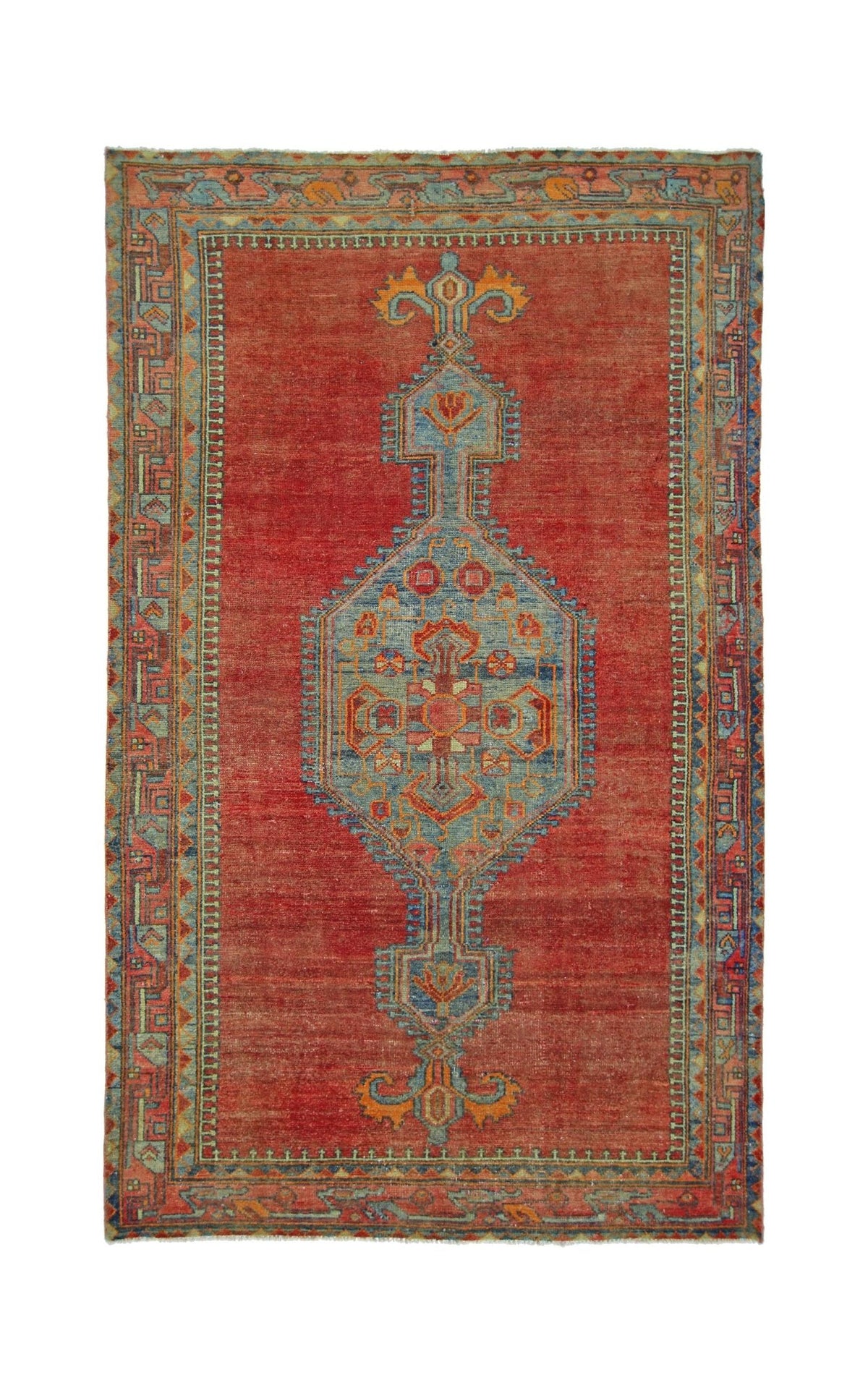 A vintage Persian rug featuring a central blue geometric medallion on a red field.
