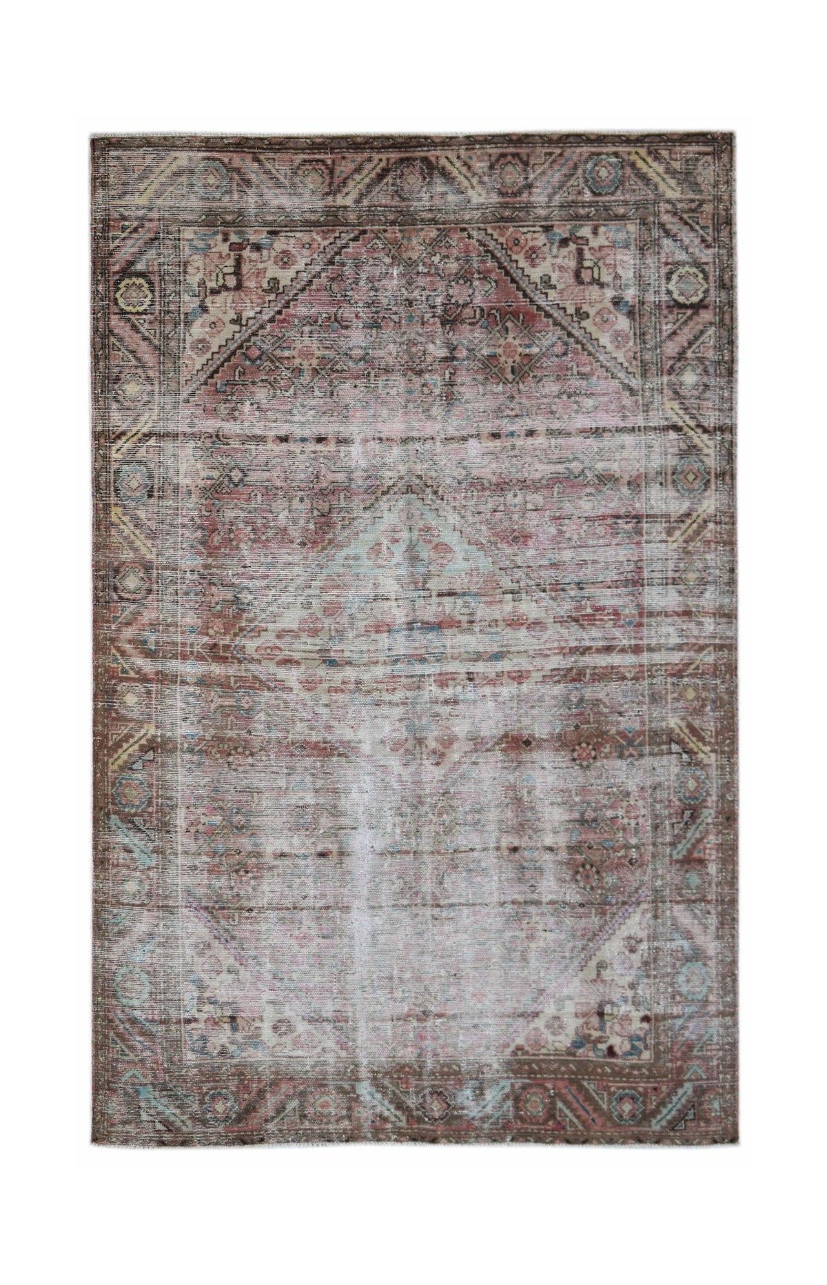 A rectangular vintage Persian rug featuring a faded geometric medallion in muted pink and brown.