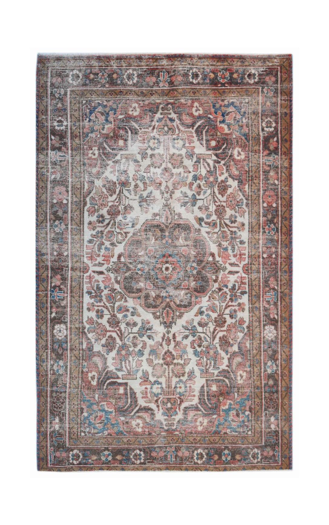 A vintage Persian rug featuring a central floral medallion in faded red, blue, and cream tones.