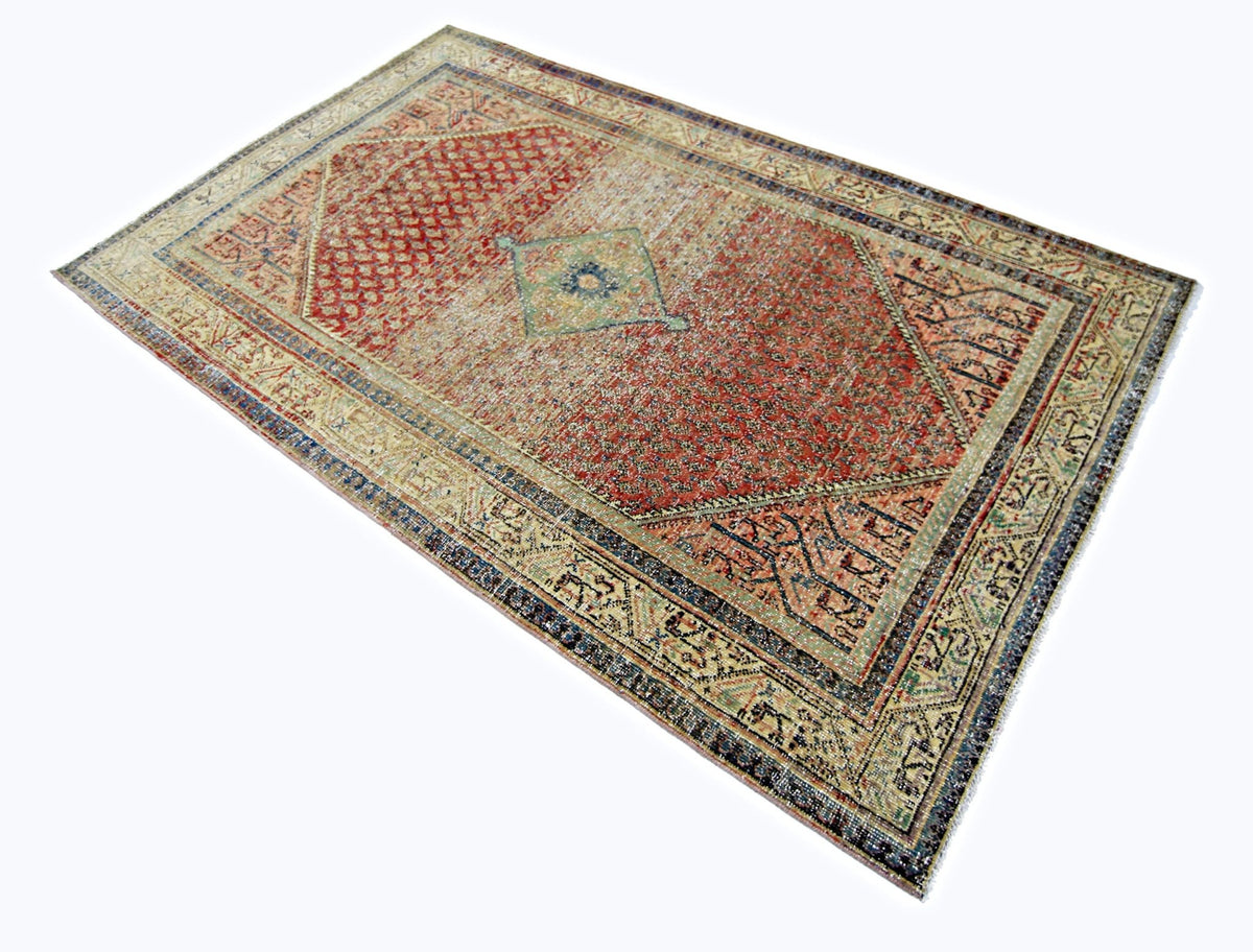 Vintage Persian Saraband rug with a red field, repeating boteh motifs, and a structured multi-coloured border.