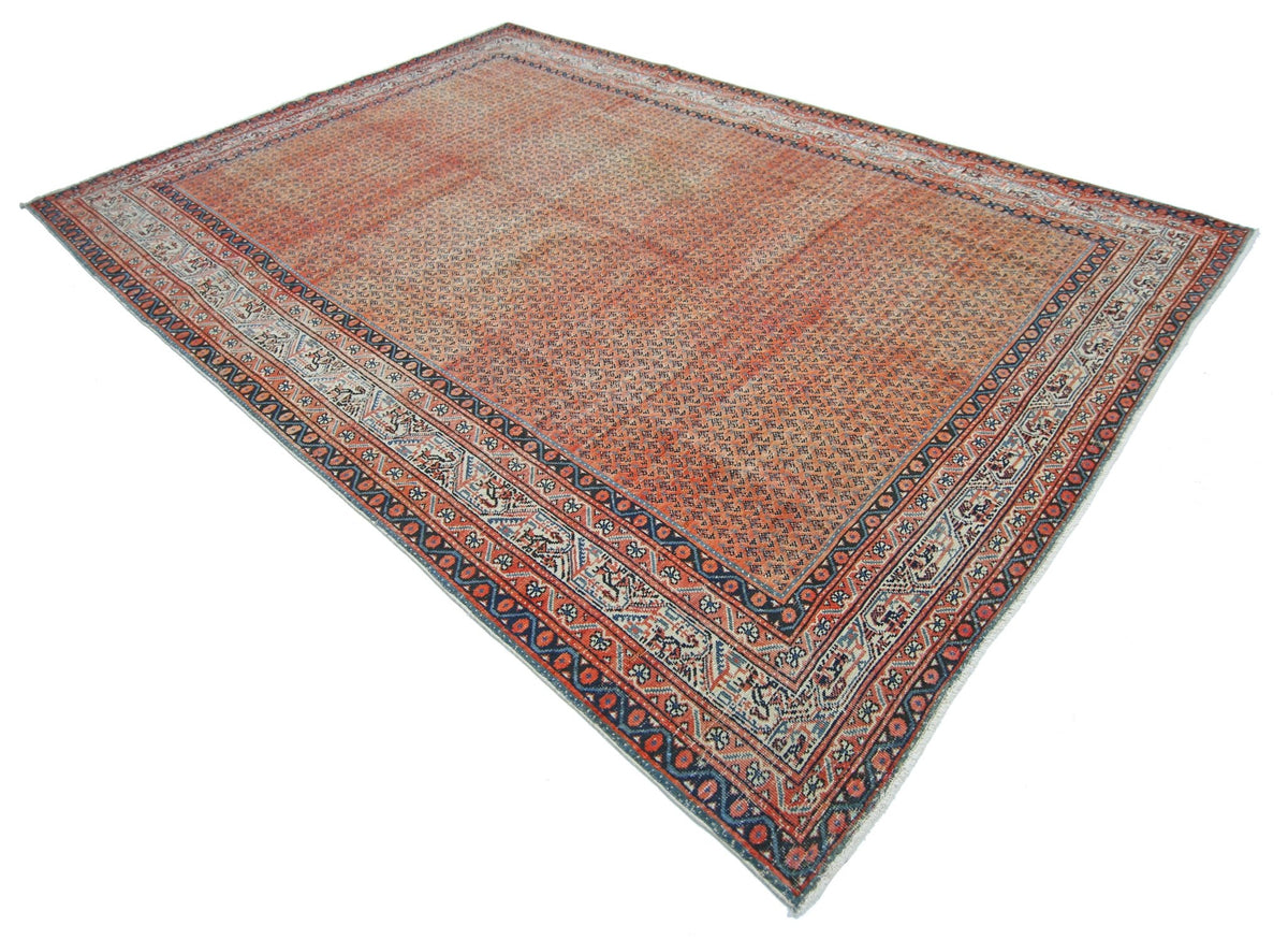 A vintage Persian Saraband rug featuring a repeating pattern in shades of red, blue, and cream.
