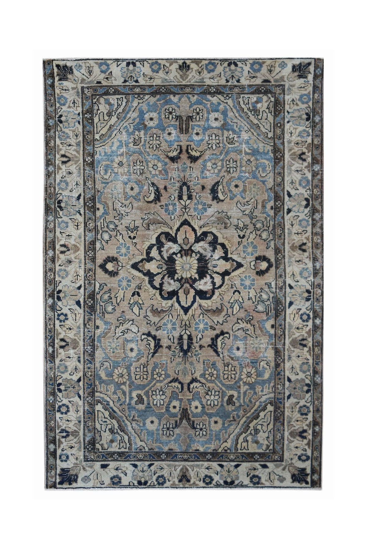 Vintage Persian Sarouk rug featuring a central floral medallion in navy, blue, and beige with intricate vine patterns.