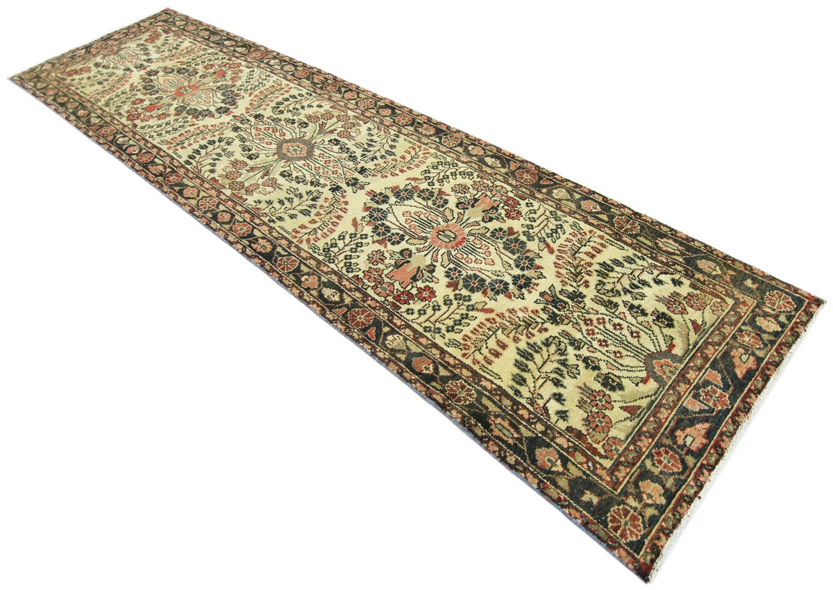 A vintage Persian Sarouk runner featuring a floral pattern in red and blue on a cream background.