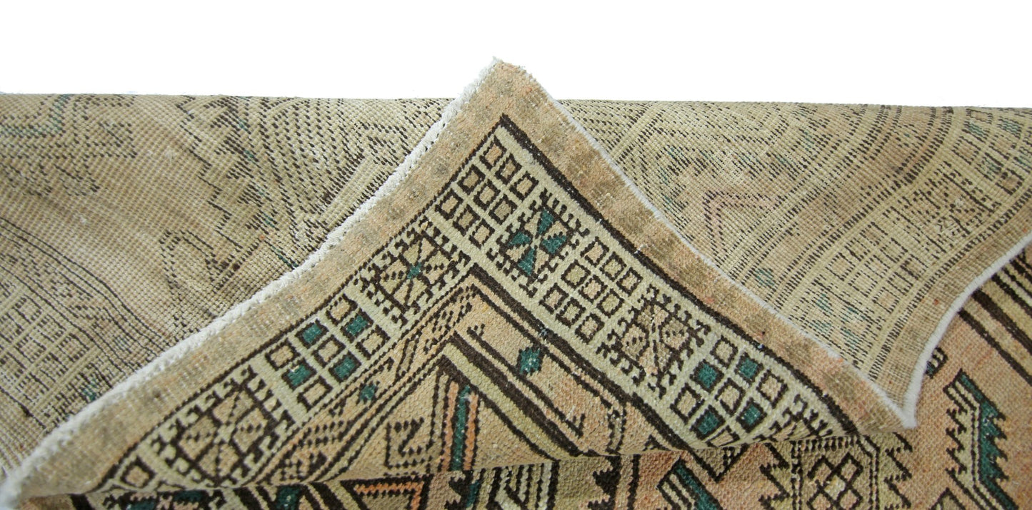 A corner view of a vintage Persian Serab runner featuring geometric patterns in wool on cotton.