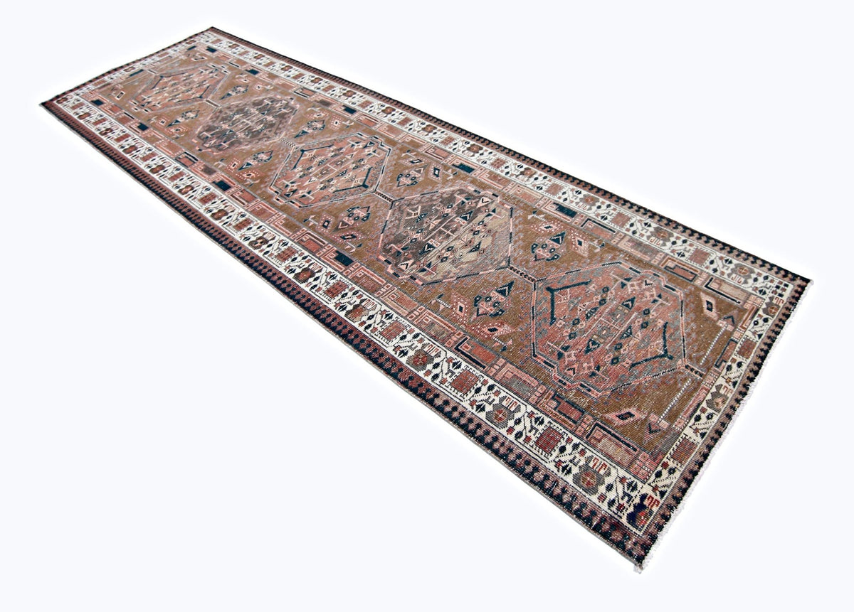 Vintage Persian Serab runner featuring geometric medallions in muted brown and cream tones with a detailed patterned border.