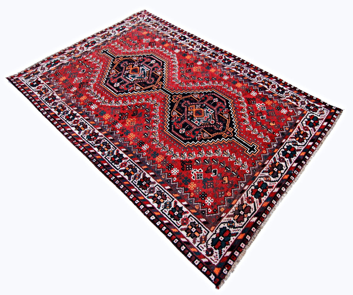 Hand-knotted vintage Shiraz rug in red wool with geometric diamond medallions and intricate tribal motifs.