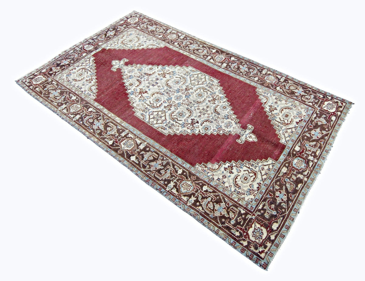 Hand-knotted vintage Persian Tabriz rug in deep red and cream with a central medallion and intricate floral border.