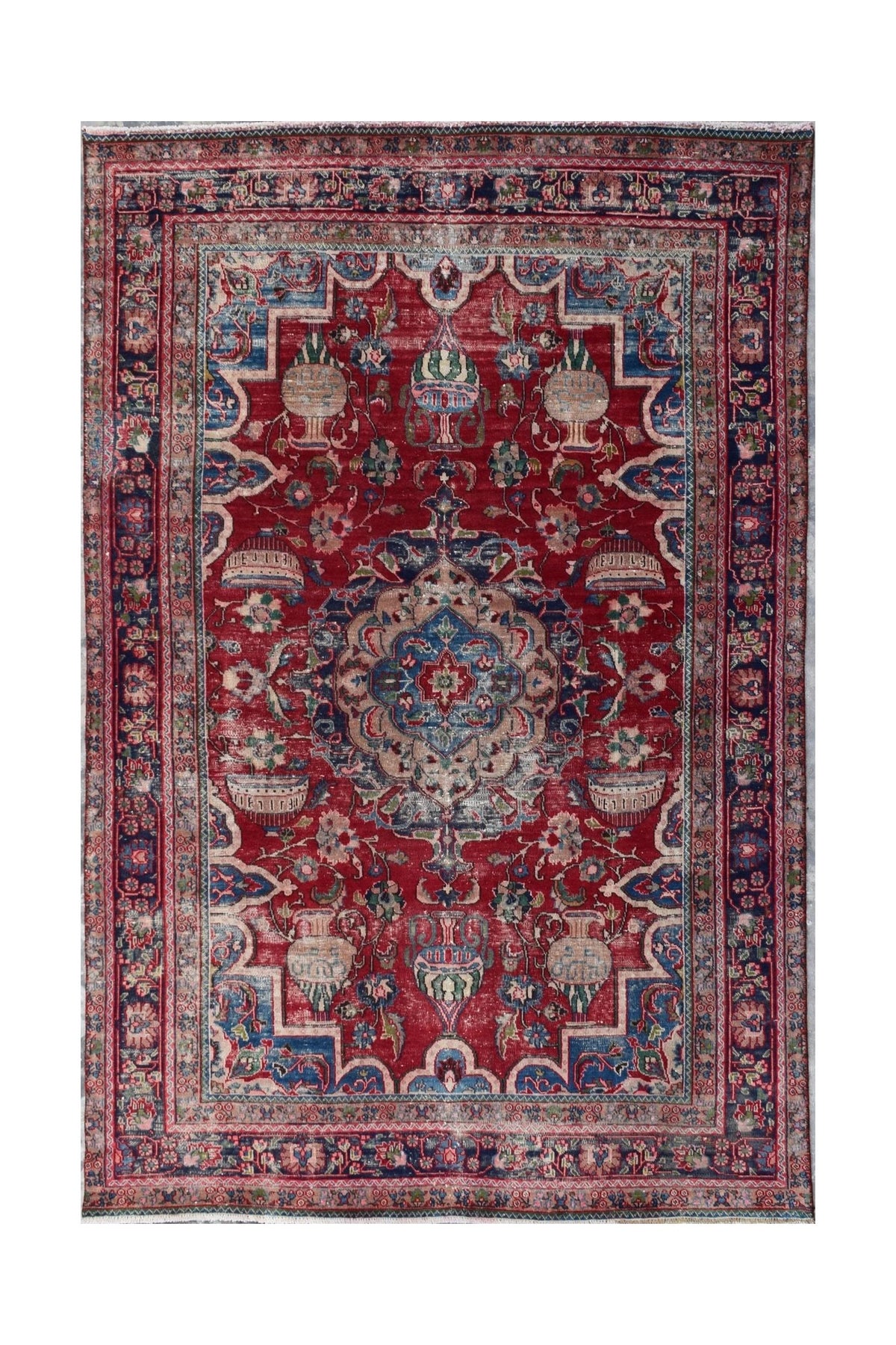 A vintage Persian Tabriz rug featuring a central medallion and intricate floral vase motifs.
