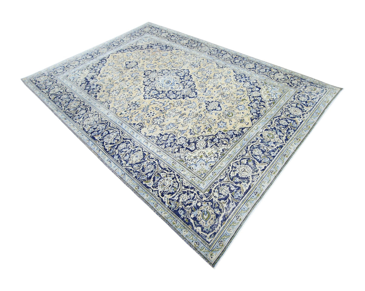 Hand-knotted vintage Persian Tabriz wool rug featuring intricate blue and cream floral patterns on a cotton foundation.