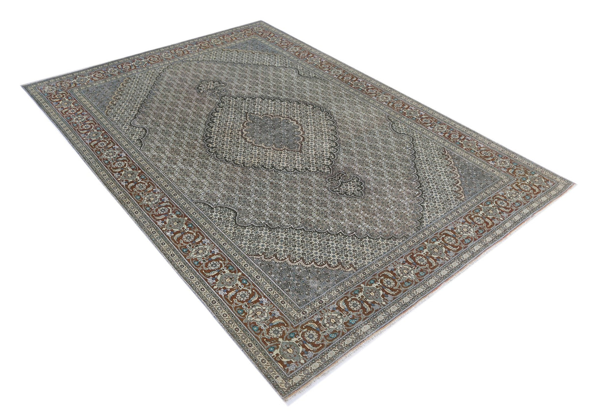 Hand-knotted vintage Persian Tabriz wool rug featuring a grey central medallion and intricate floral border patterns.