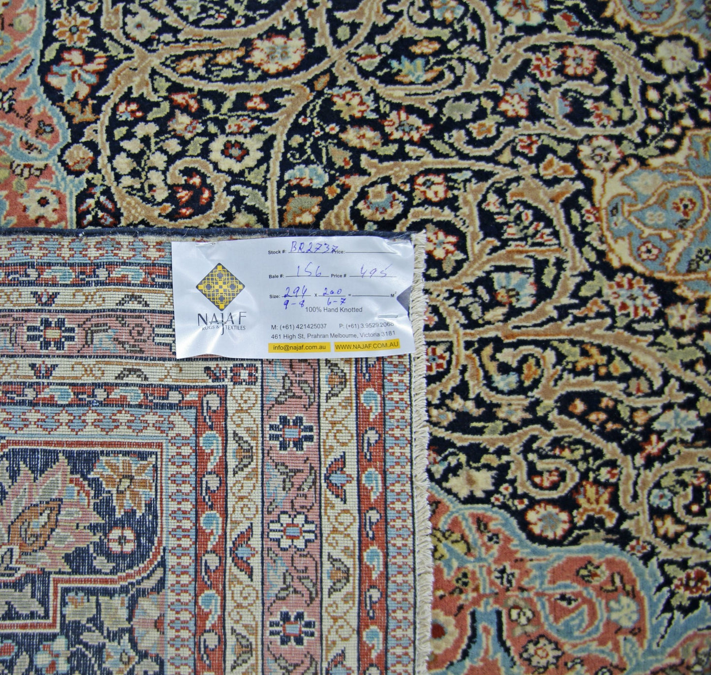 A vintage Persian Tabriz rug featuring intricate floral patterns in blue, cream, and rust tones.
