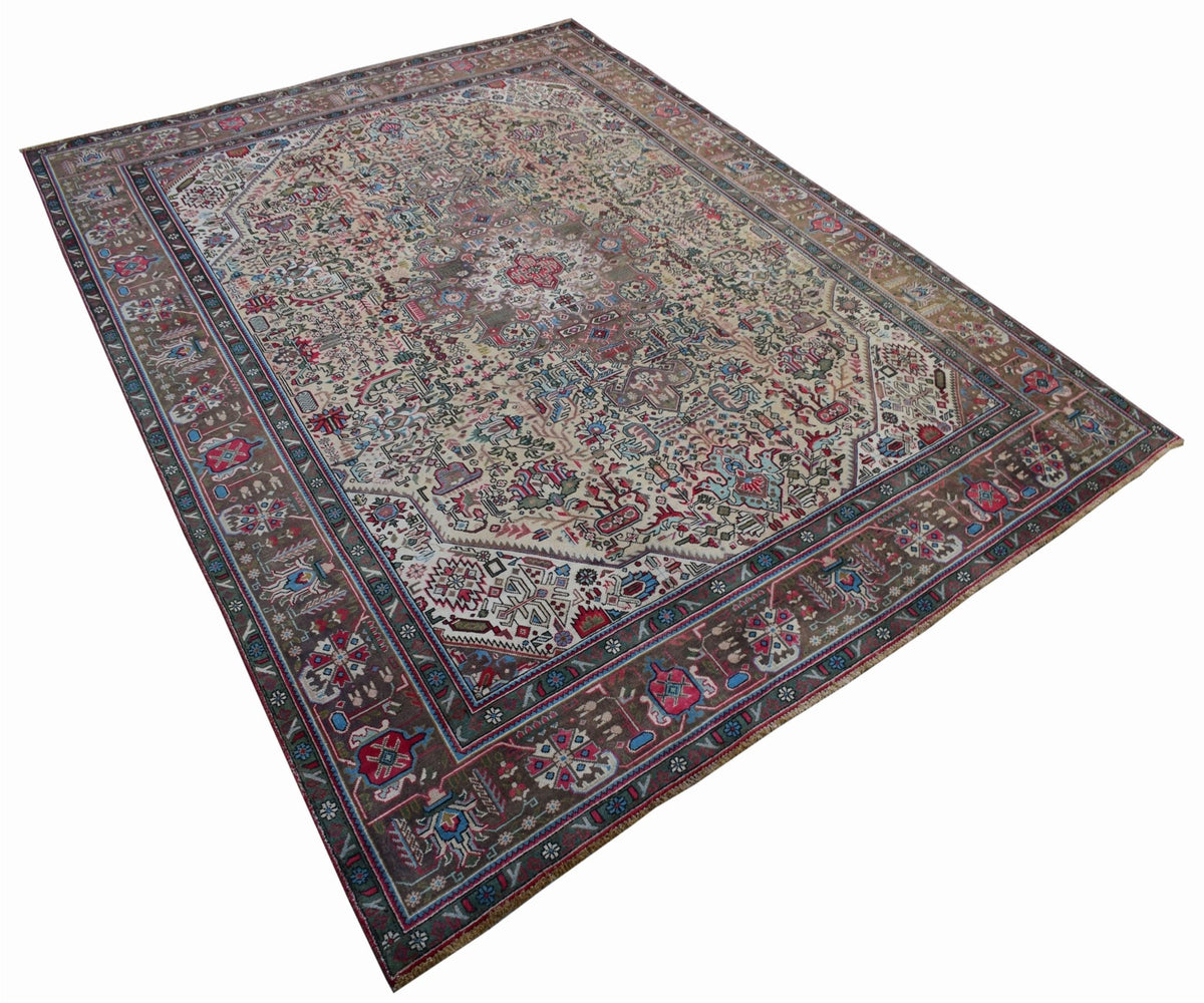 A vintage handwoven Persian Tabriz rug featuring intricate floral patterns in a muted color palette.