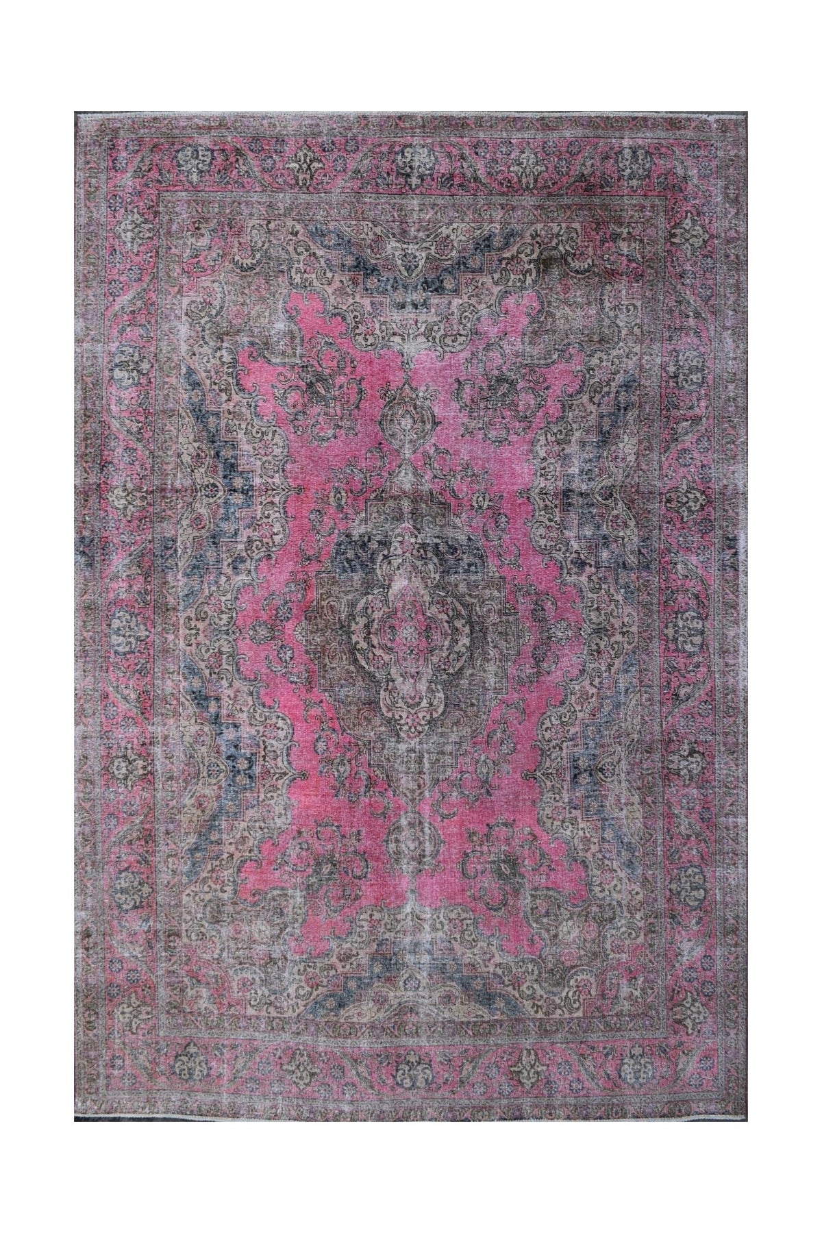 A vintage Persian Tabriz rug featuring intricate floral patterns in shades of pink and grey.