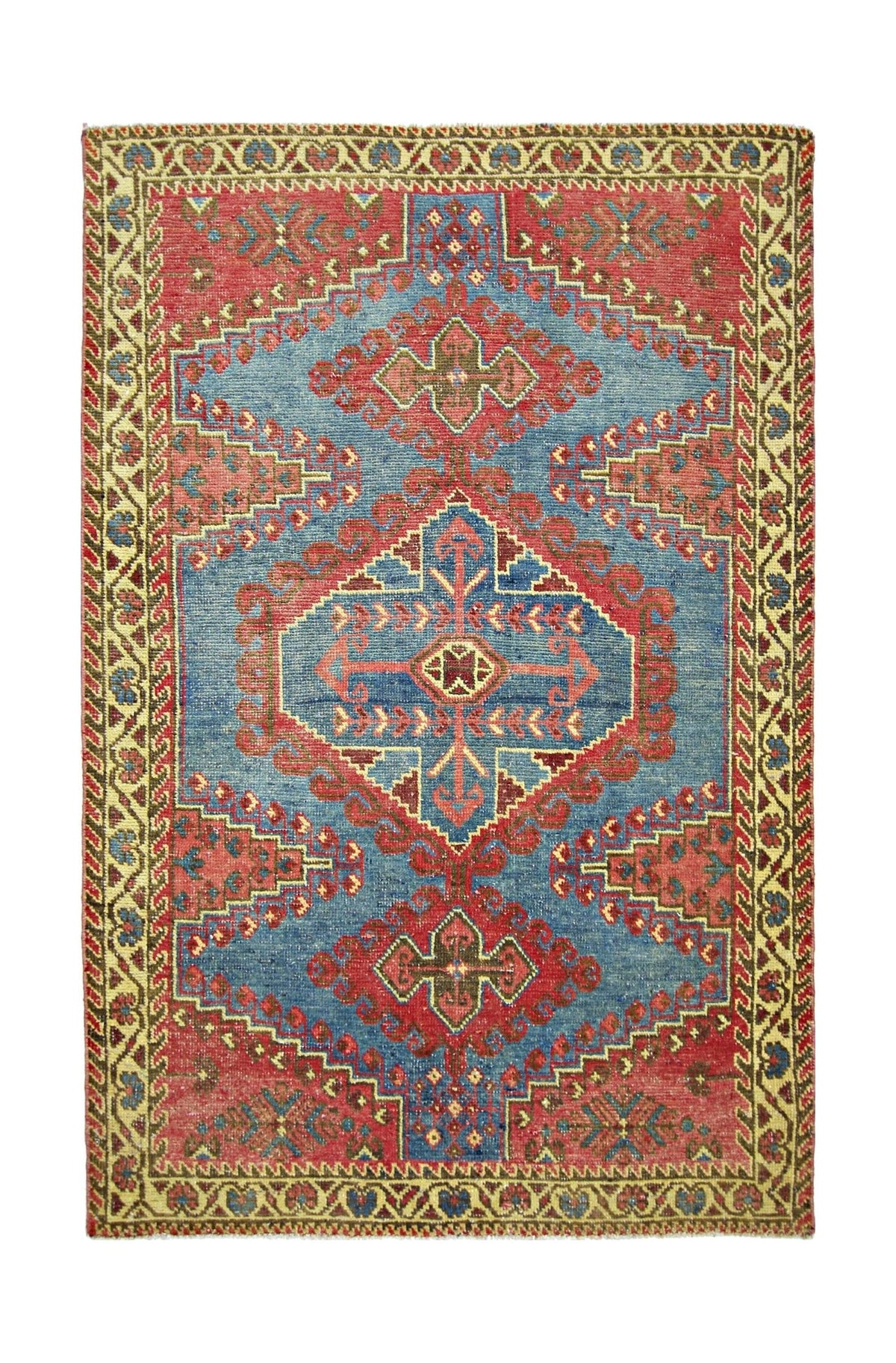 A vintage handmade Persian Wiss rug featuring a geometric medallion pattern in red and blue.