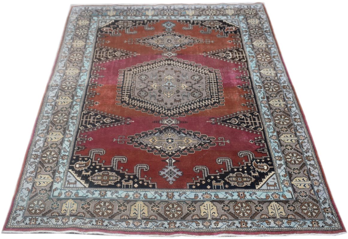 A vintage handmade Persian Wiss rug featuring a central geometric medallion on a red field.