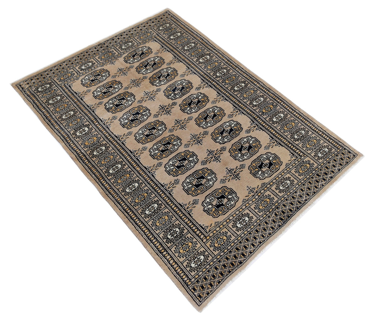 Hand-knotted Pakistani Princess Bokhara rug with a beige field, repeating black and white gul motifs, and a detailed geometric border.