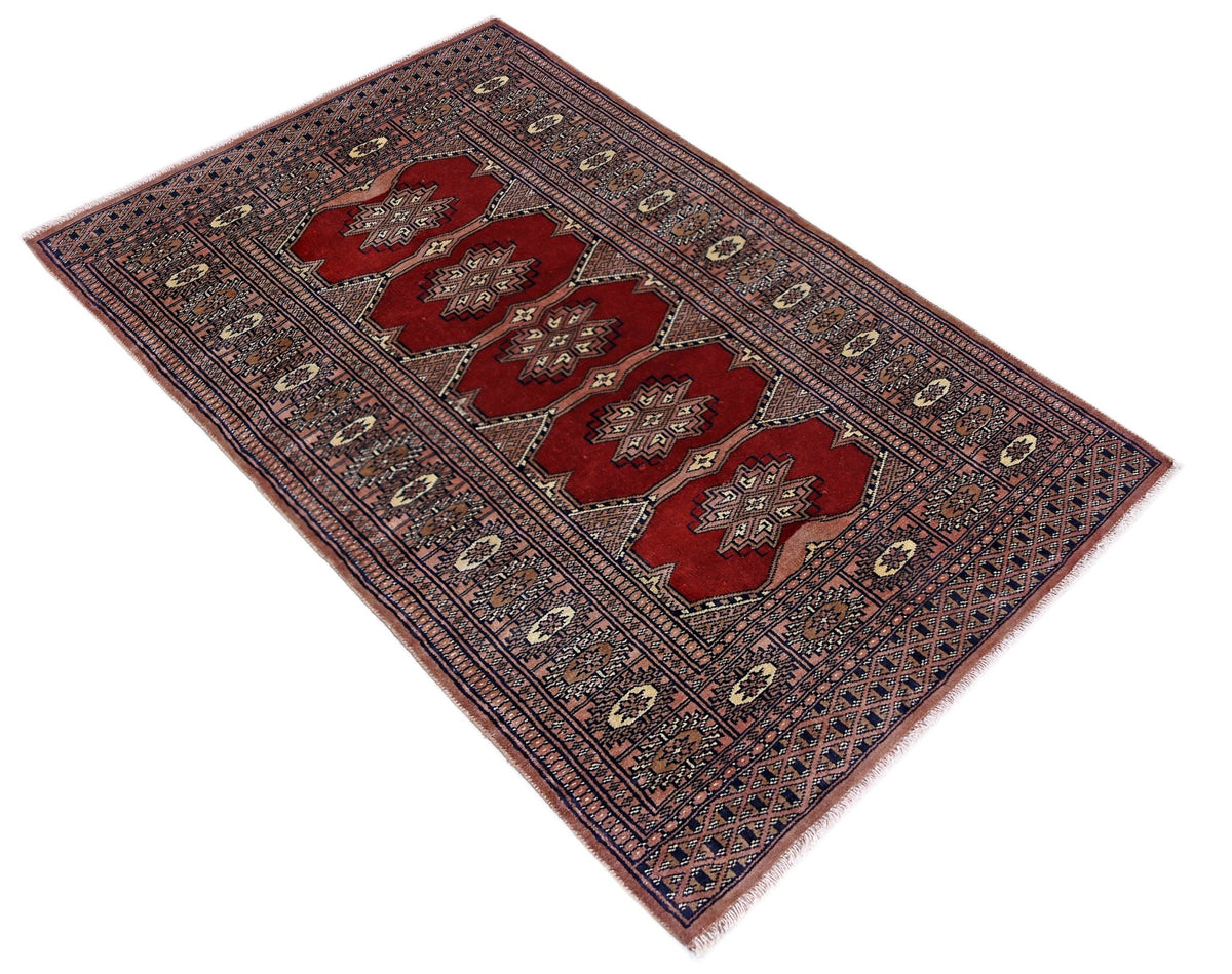 Hand-knotted Pakistani Princess Bokhara rug in deep red with intricate geometric gul patterns and a soft wool pile.