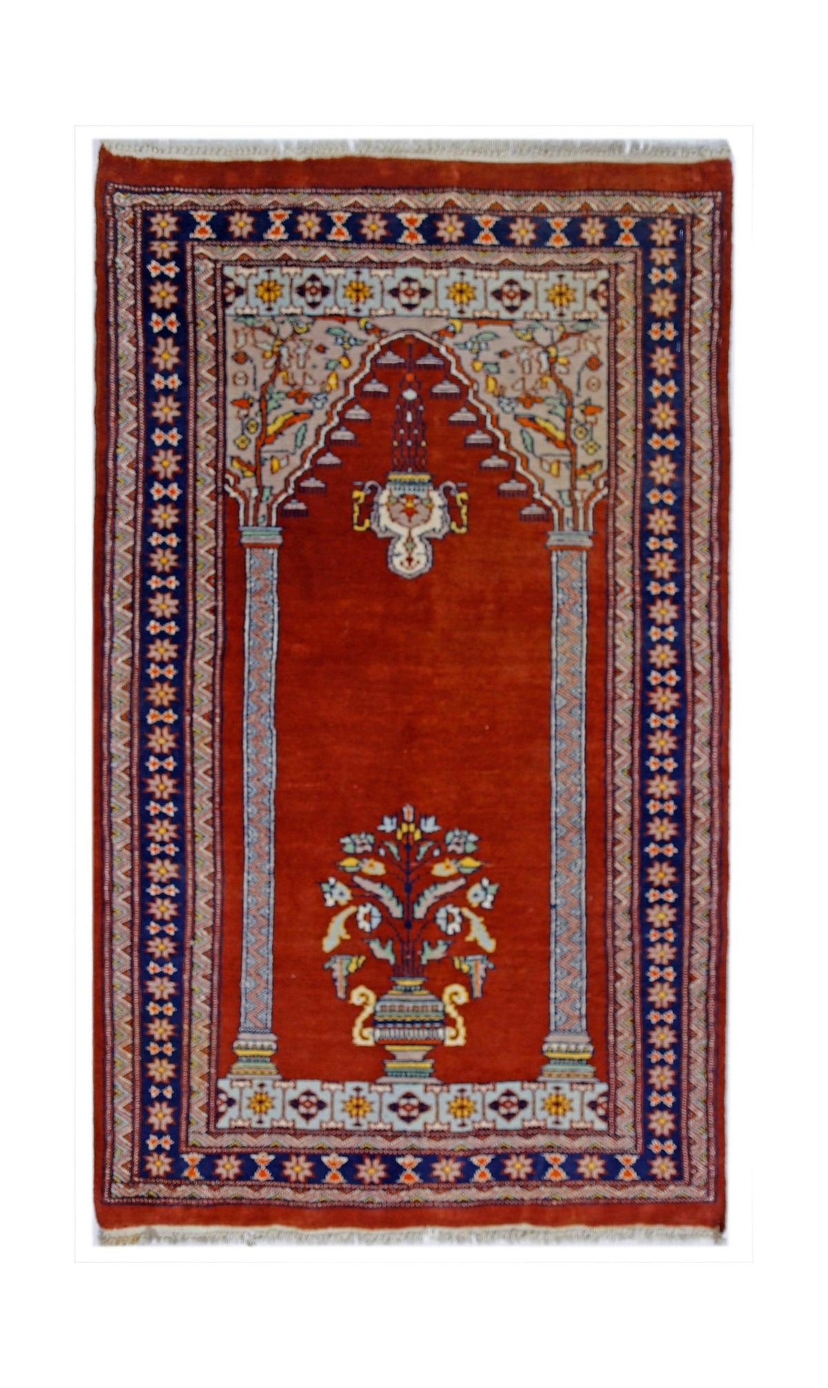 Hand-knotted Pakistani wool rug featuring a red prayer niche design with floral motifs, decorative borders, and white fringe.