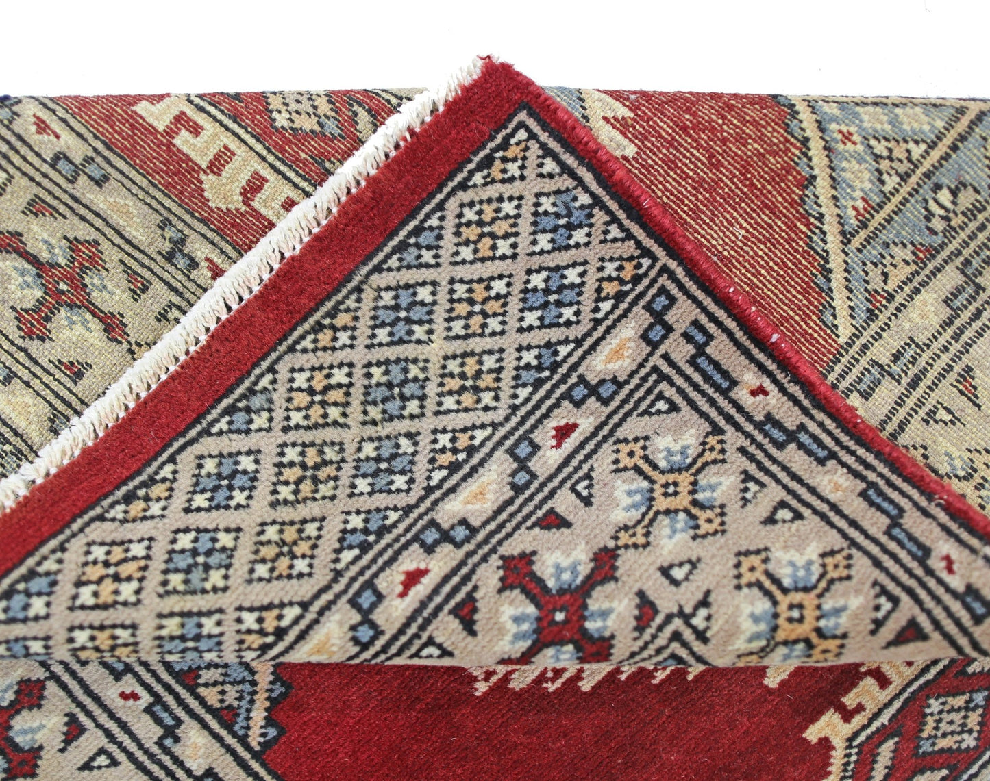 A vintage Pakistani Princess Bokhara rug with a red field and intricate geometric patterns.