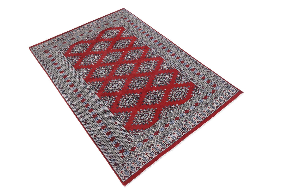 Hand-knotted Pakistani Princess Bokhara rug in deep red with repeating blue and cream gul motifs and a detailed geometric border.