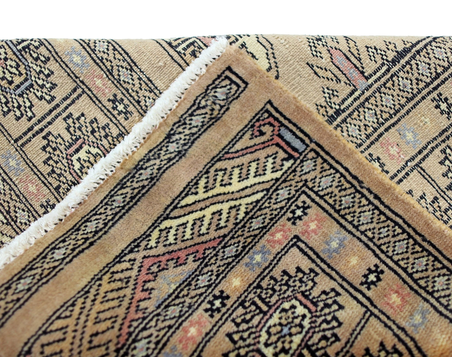 A vintage Pakistani Princess Bokhara rug featuring intricate geometric patterns in warm tones.