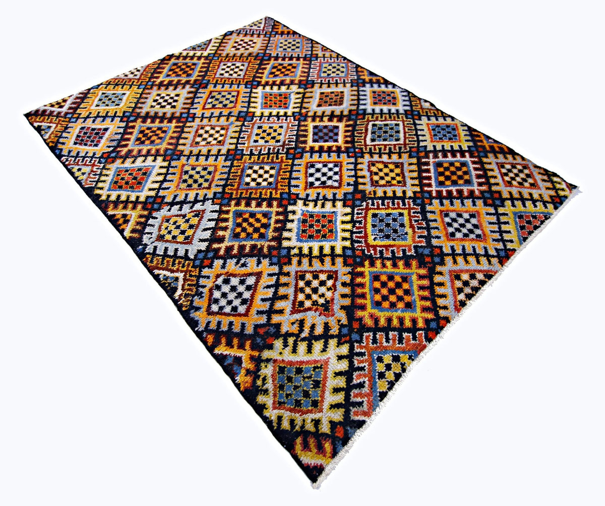 Vintage Turkish Anatolian rug with a vibrant geometric grid pattern in red, blue, yellow, and black with a short fringe.