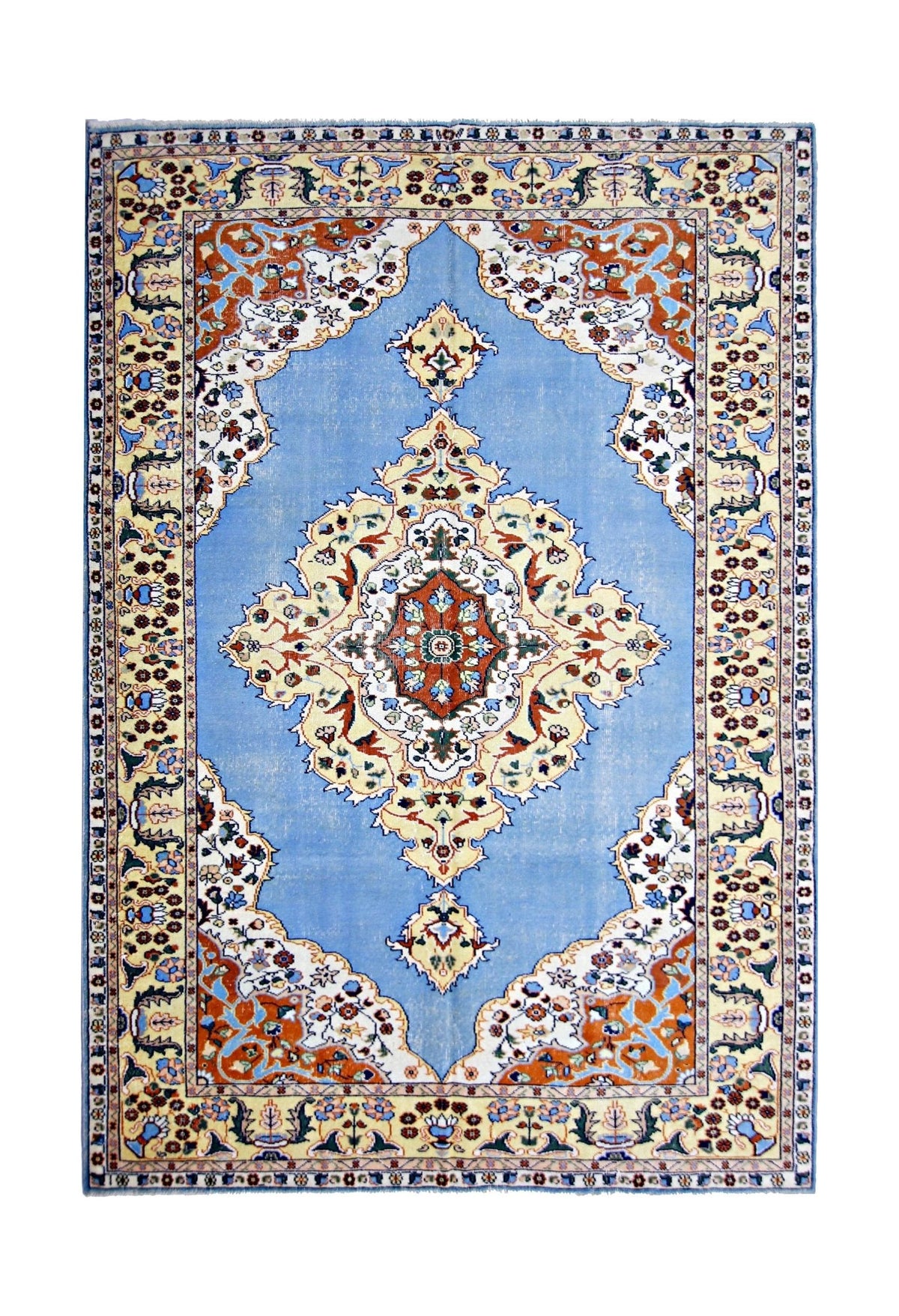 Vintage Anatolian rug with a blue field, central medallion, and intricate floral border in cream, orange, and navy tones.