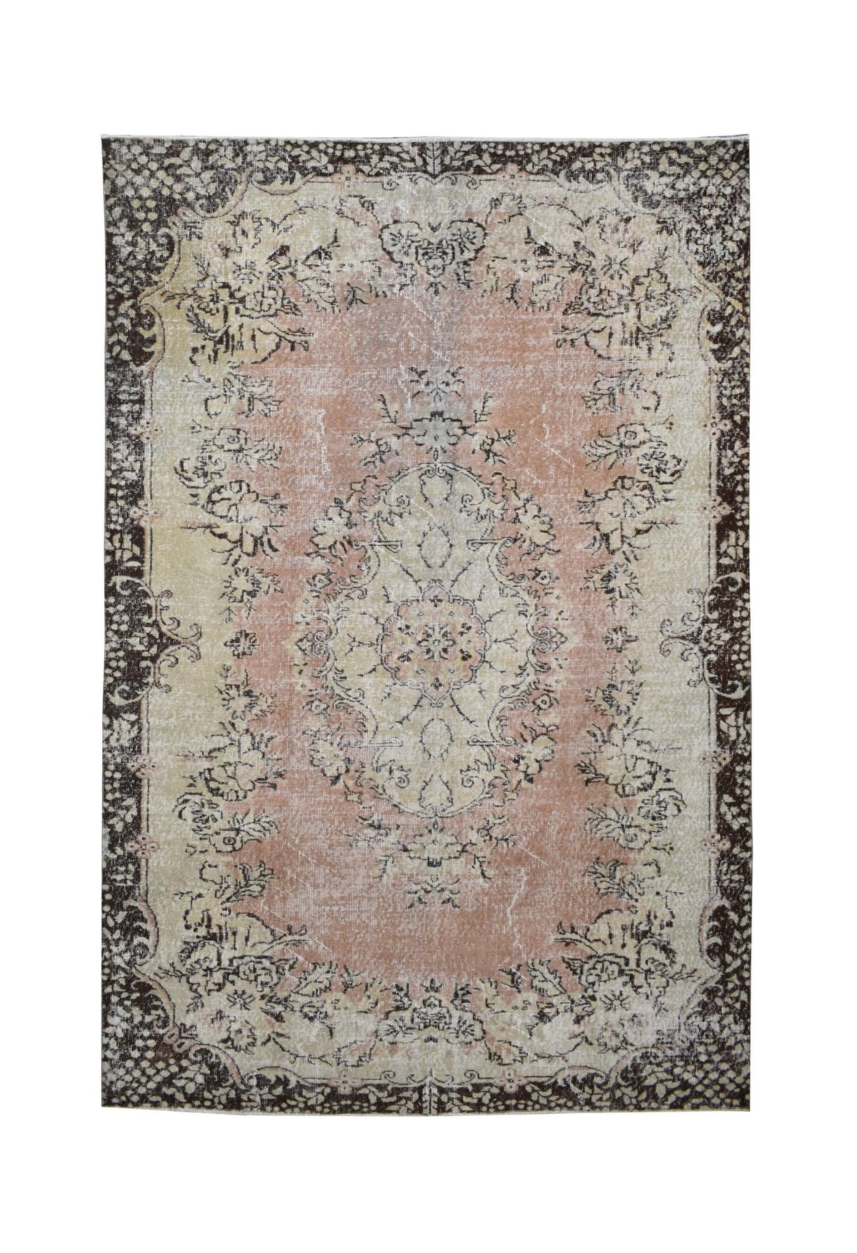 A vintage Turkish Isparta rug featuring a floral medallion on a pink field with a dark border.