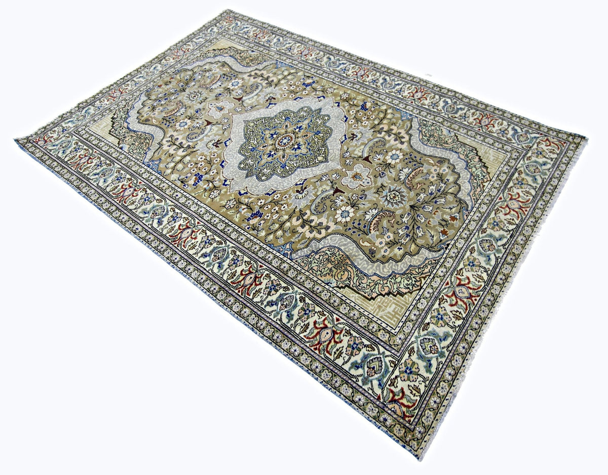 Vintage Kayseri rug featuring a beige field, central floral medallion, and intricate blue and cream scrolling vine borders.