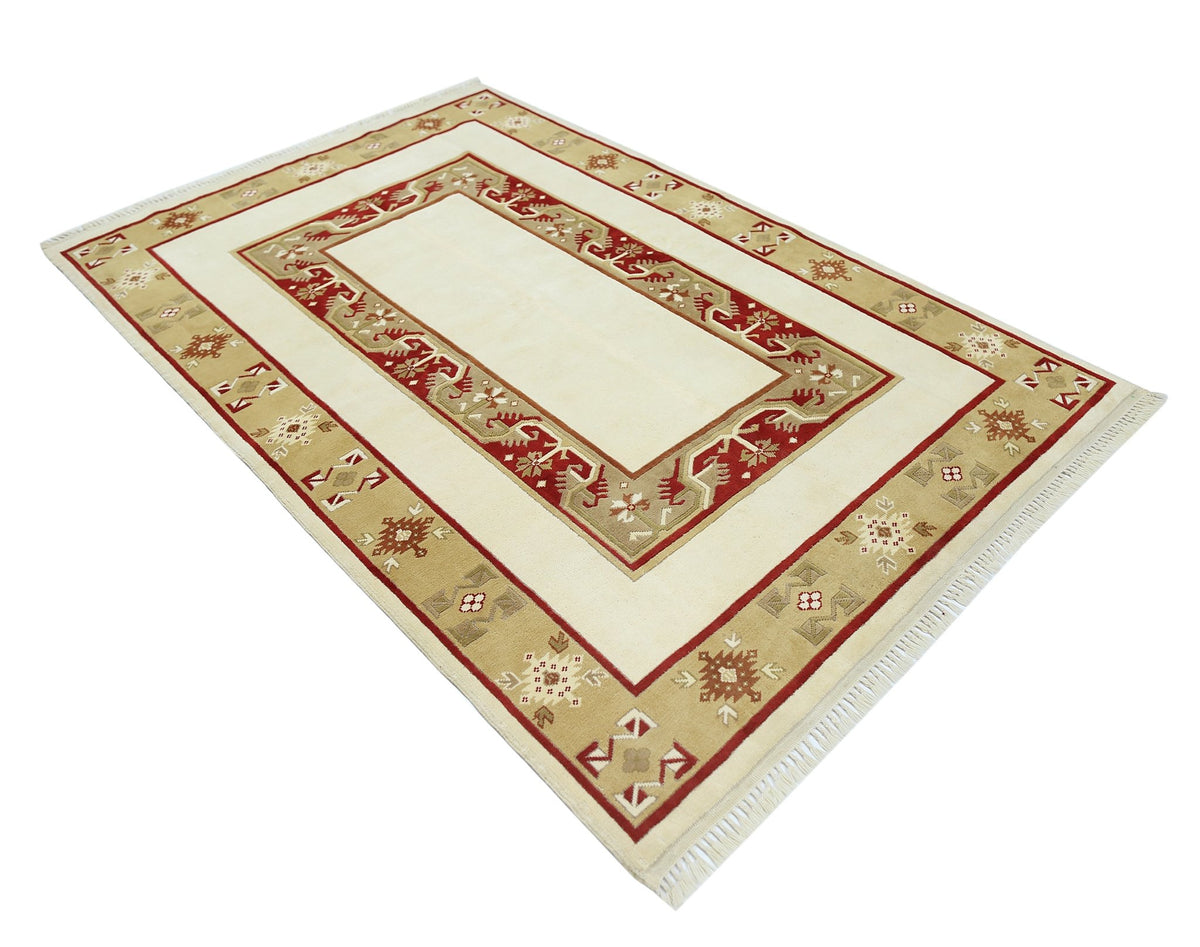 A vintage Turkish Milas rug featuring a cream center with a red and tan geometric border.