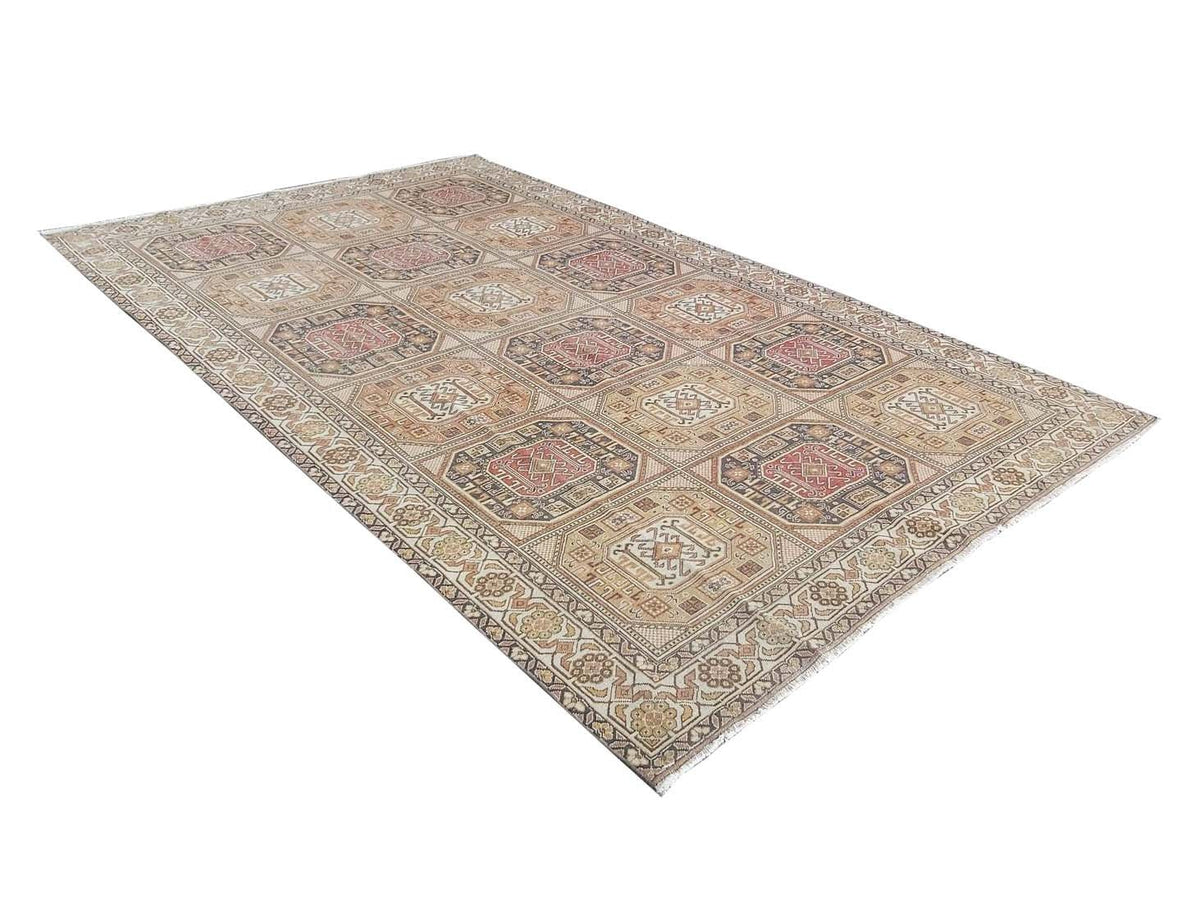 A vintage Turkish Oushak rug featuring a repeating geometric medallion pattern in muted earth tones.