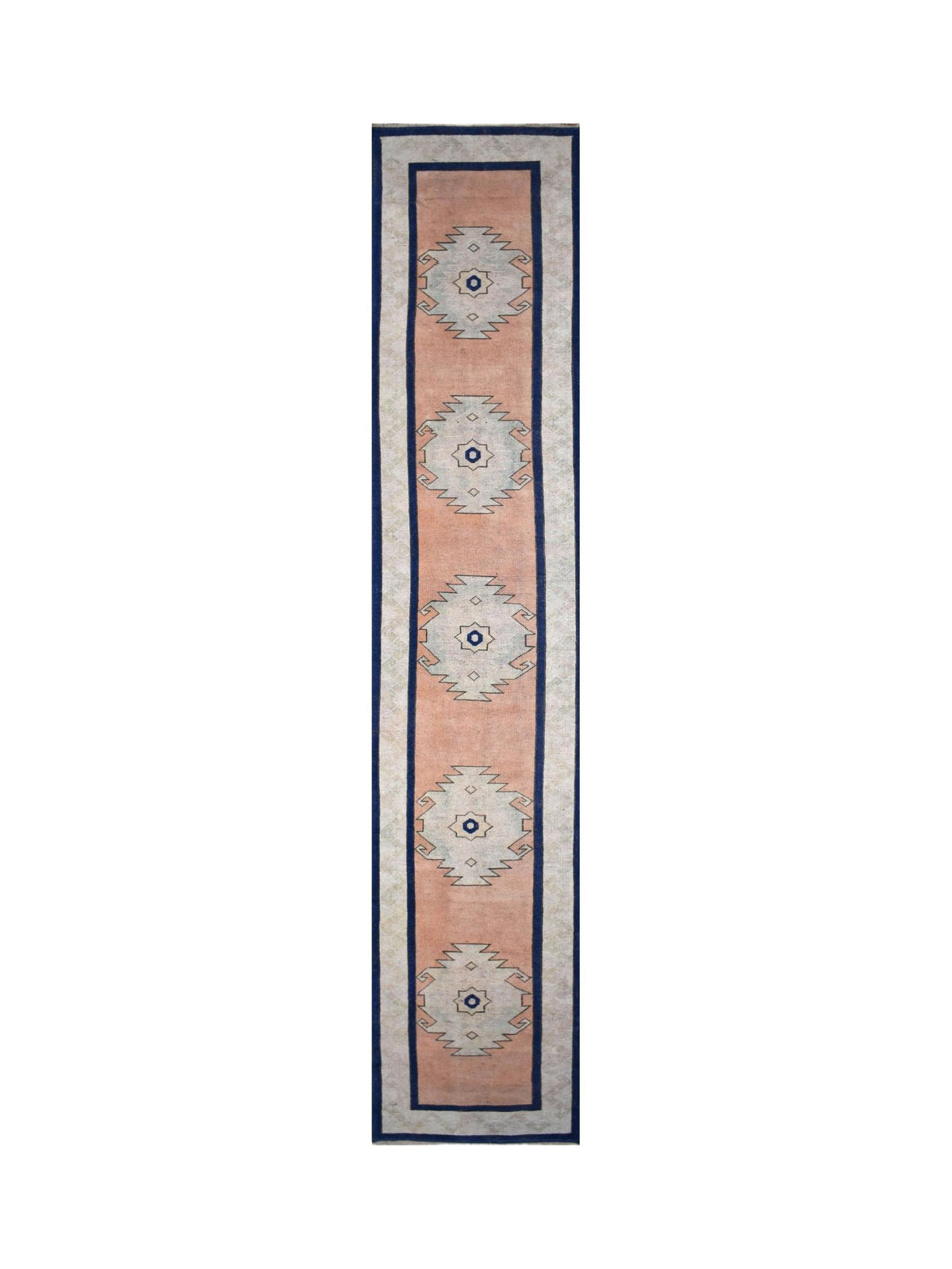 Vintage Turkish Oushak runner featuring soft peach tones, geometric medallions, and a deep blue border.