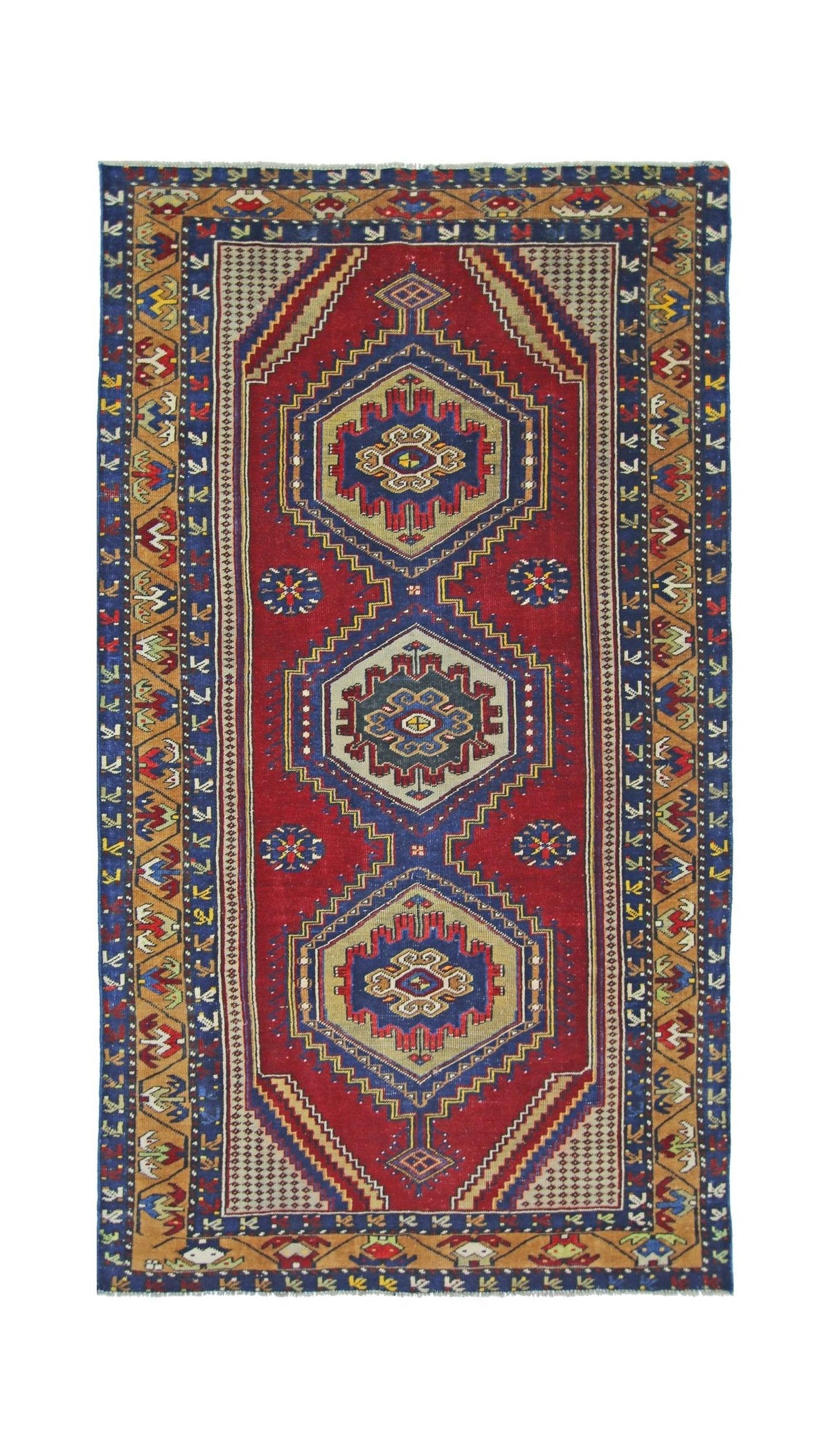 Vintage Taspinar rug with a red field, three central geometric medallions, and intricate ochre and blue borders.