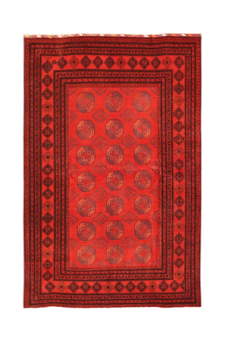 A vintage handmade Afghan Turkmen rug featuring a repeating red elephant foot motif.