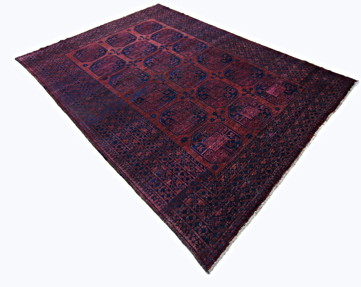 Hand-knotted vintage Ersari rug in deep madder red and indigo blue with a repeating elephant's foot gul medallion pattern.